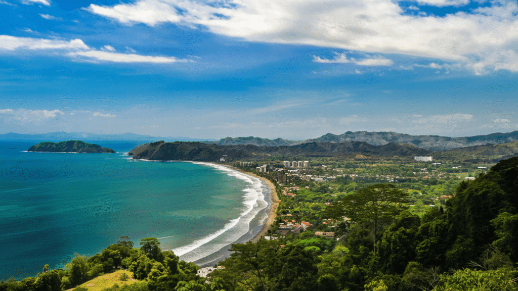 Surfers catching waves at Jaco Beach Costa Rica with golden sunset and lively beach town background